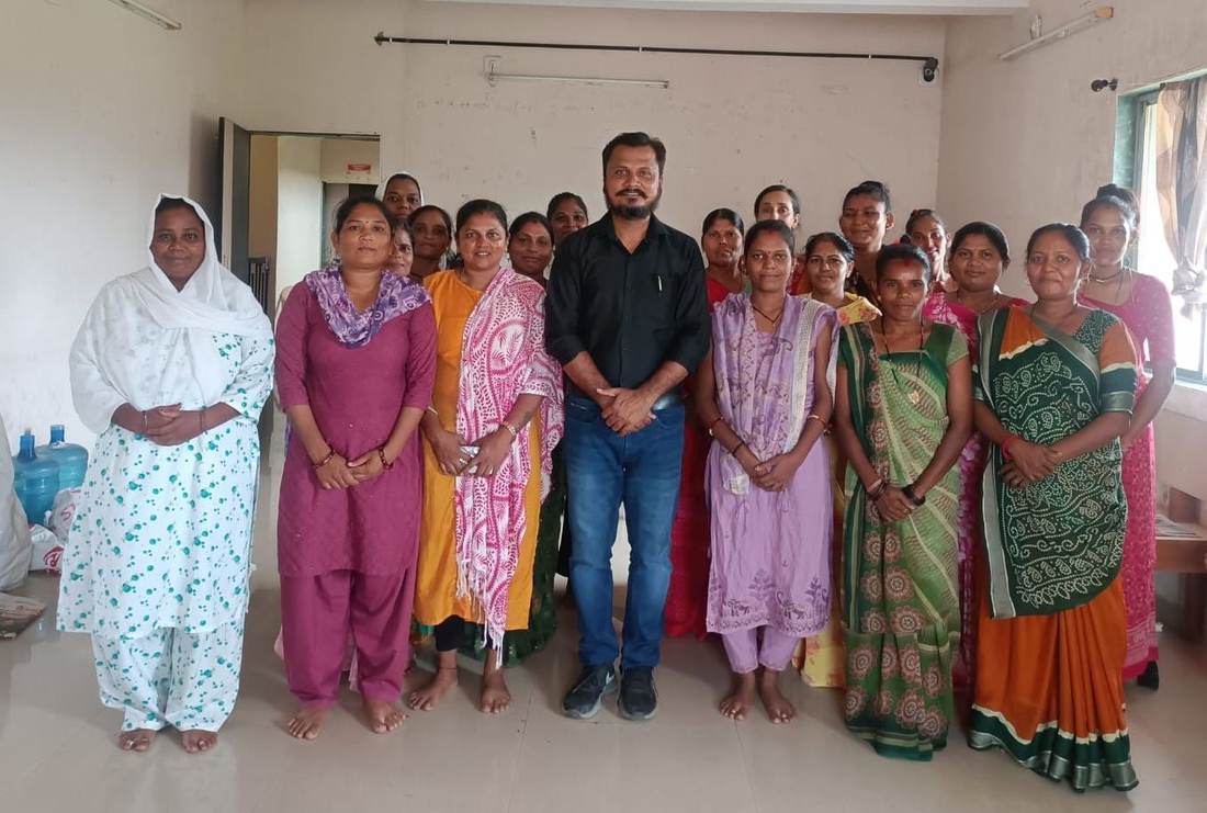 Foundation member meeting with a group of community women