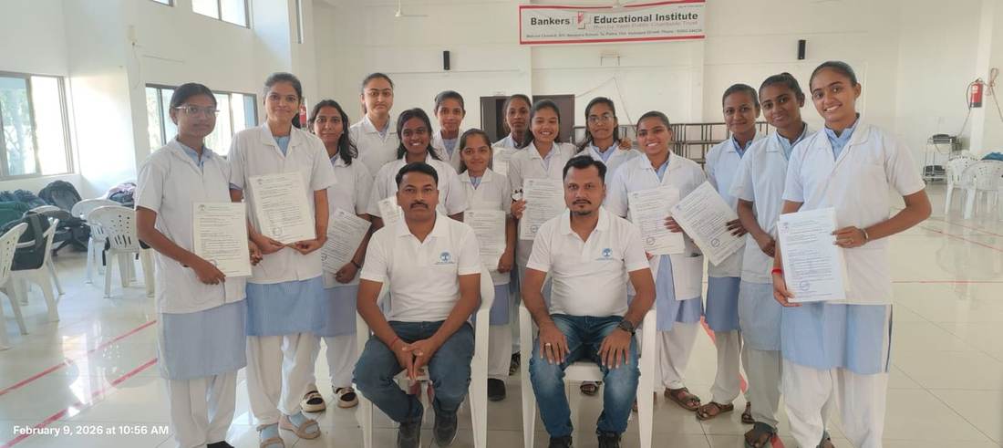 Young women in nursing uniforms holding certificates after a health training programme